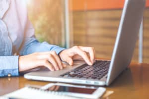 person typing on laptop